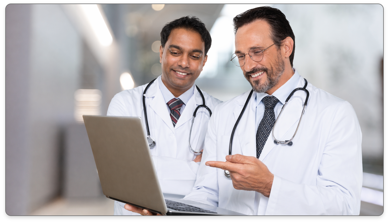 Medical professionals discussing over a laptop